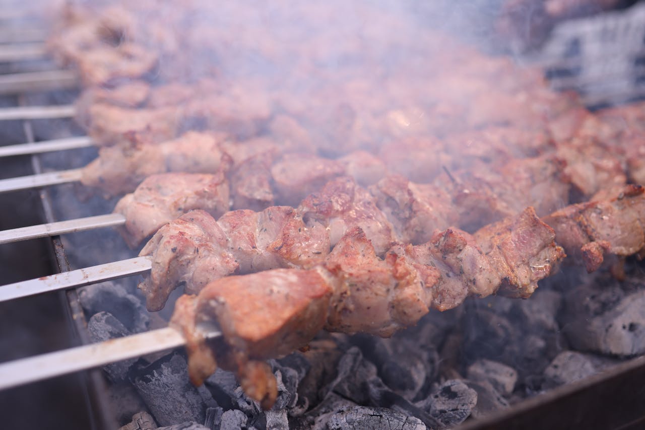 Delicious grilled skewers sizzling over charcoal, perfect for outdoor grilling scenes.